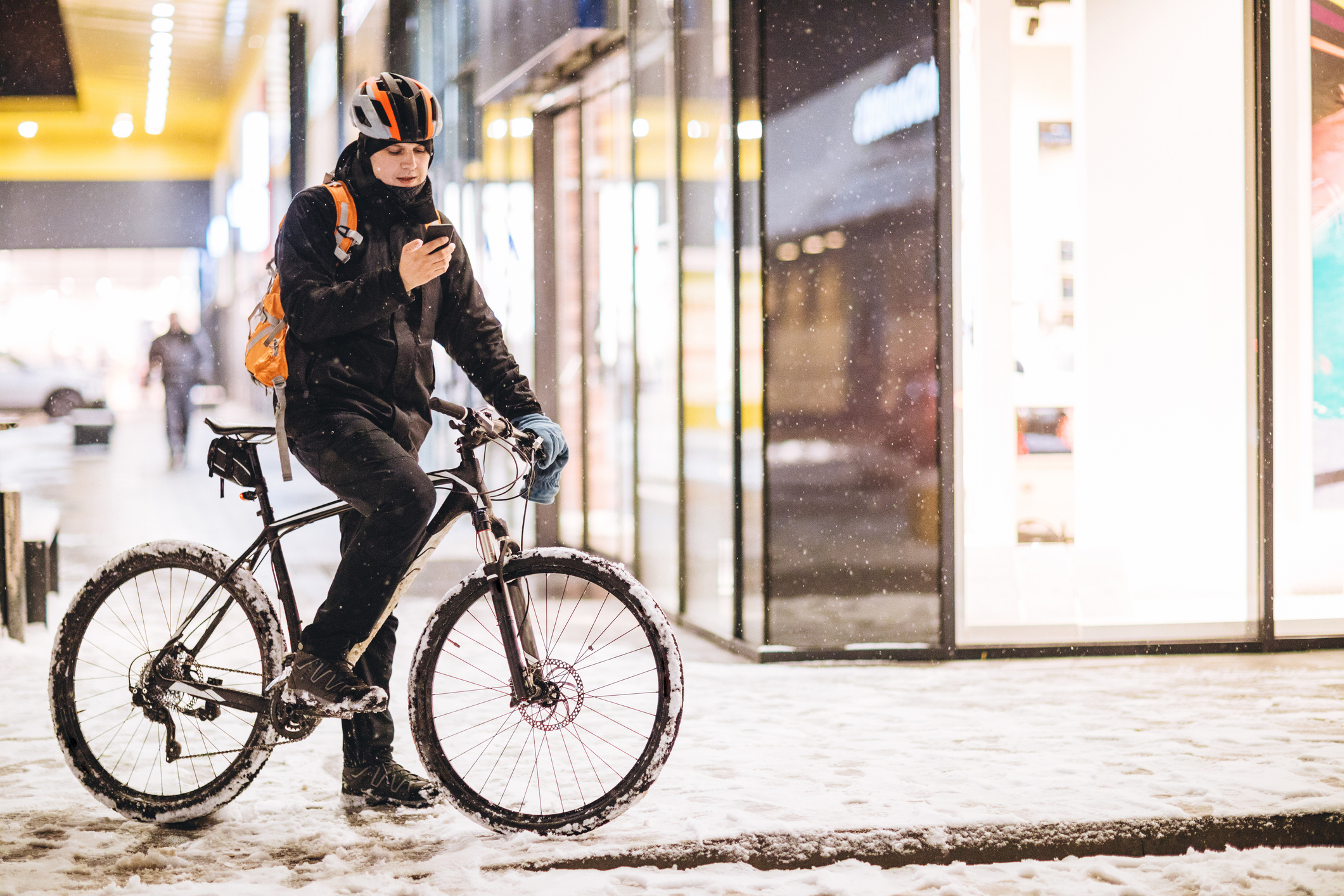 a man cycling on a snowy street