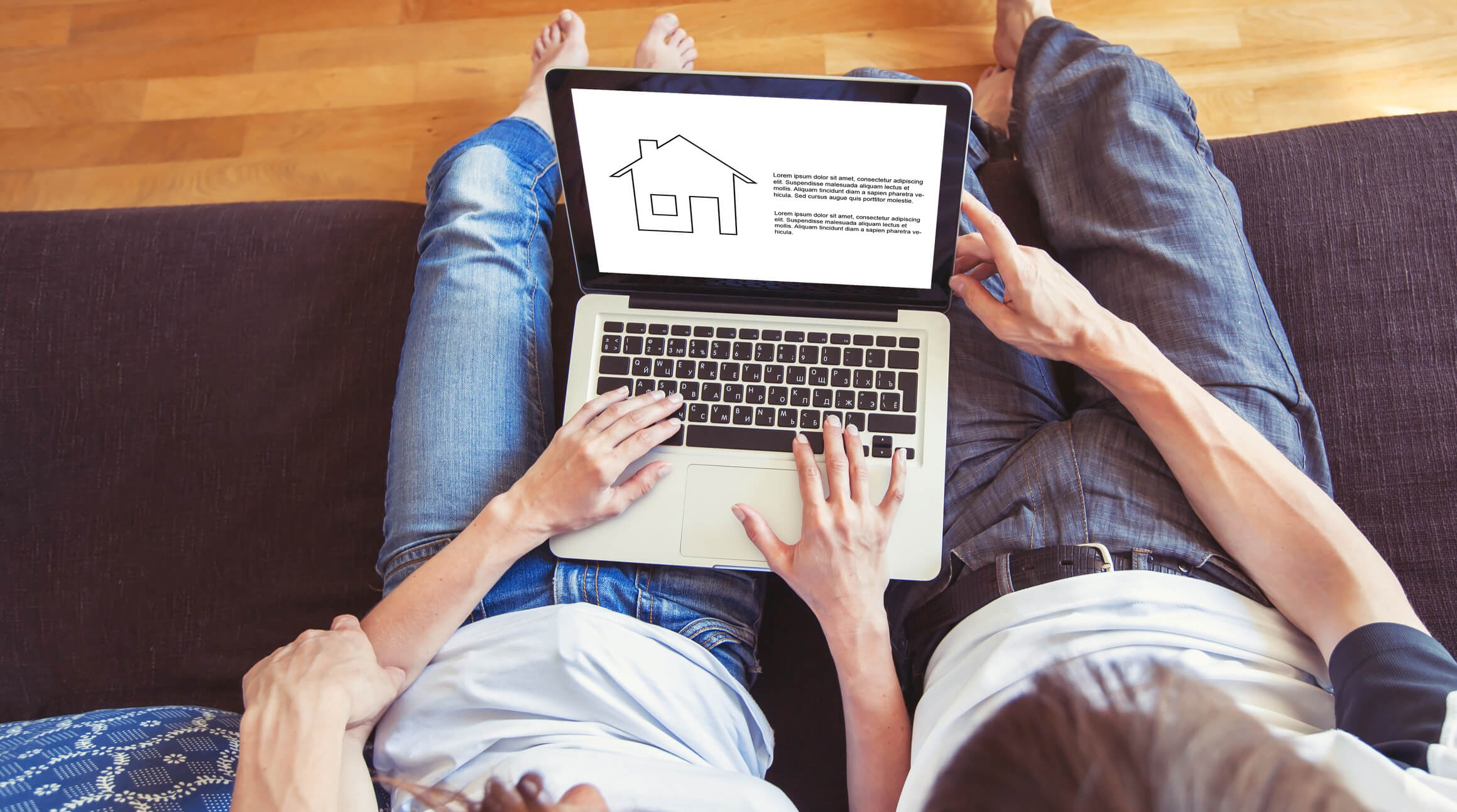 Couple browsing online house tool on their laptop