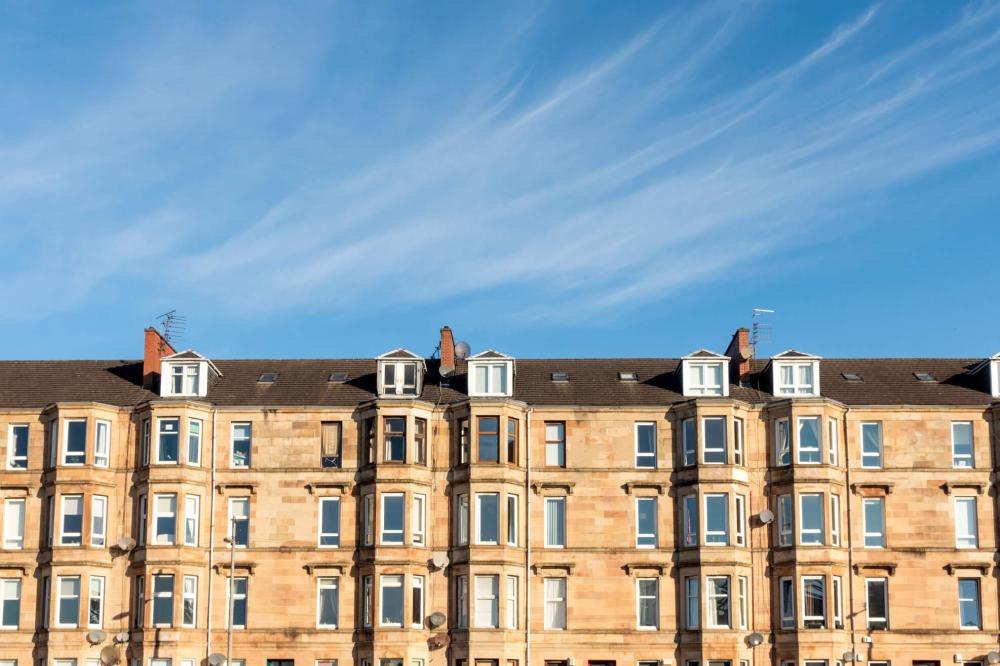 Tenement flats in Edinburgh against a blue sky